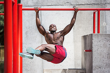 Image showing Athlete doing exercises at stadium