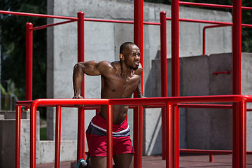 Image showing Athlete doing exercises at stadium