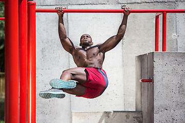 Image showing Athlete doing exercises at stadium