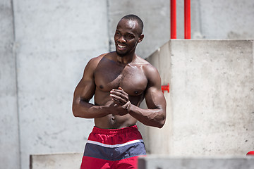 Image showing Athlete doing exercises at stadium