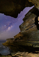 Image showing Milky Way viewed through a narrow crack in coastal  rock formati