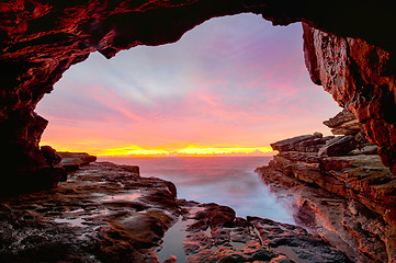 Image showing Coastal cave views to glorious sunrise over the ocean