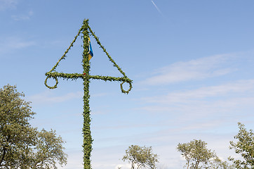 Image showing Swedish maypole by a blue sky