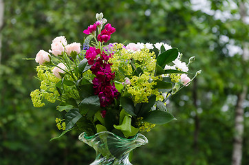 Image showing Summer flowers in a bouquet with a green background outdoors