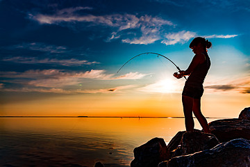 Image showing Woman fishing on Fishing rod spinning in Norway.