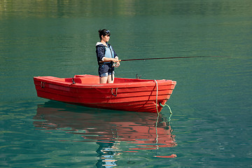 Image showing Woman fishing on a boat.