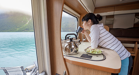 Image showing Woman in the interior of a camper RV motorhome with a cup of cof