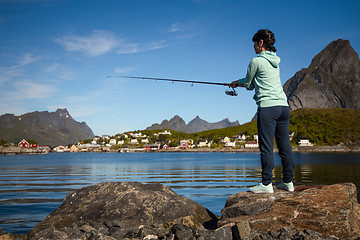 Image showing Woman fishing on Fishing rod spinning in Norway.