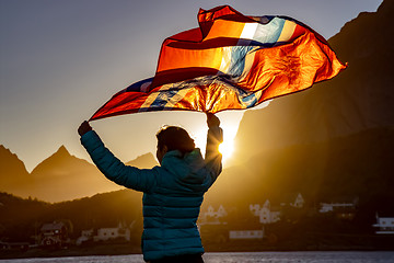 Image showing Woman waving the flag of Norway at sunset