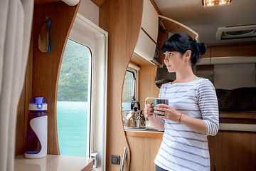 Image showing Woman in the interior of a camper RV motorhome with a cup of cof