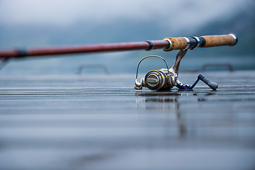 Image showing Fishing rod spinning blurred background