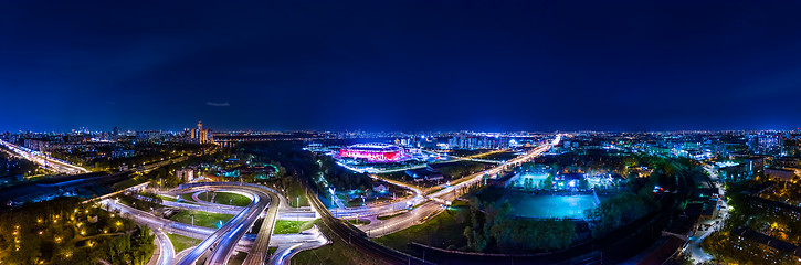 Image showing Night Aerial view panorama of a freeway intersection traffic tra