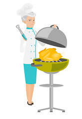 Image showing Caucasian chef cooking chicken on barbecue grill.