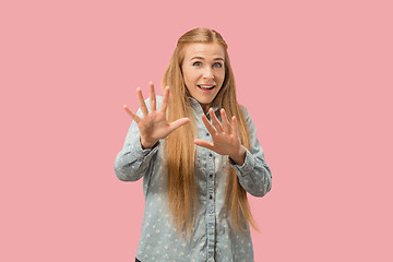 Image showing Portrait of the scared woman on pink