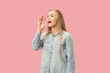 Image showing Isolated on pink young casual woman shouting at studio