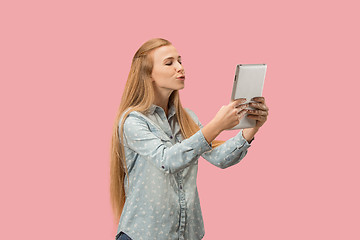 Image showing The happy businesswoman with red laptop on pink