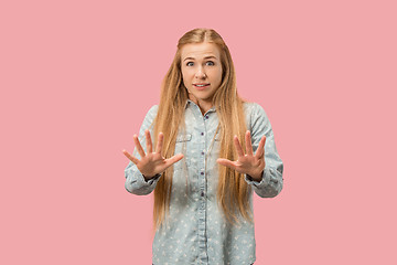 Image showing Portrait of the scared woman on pink