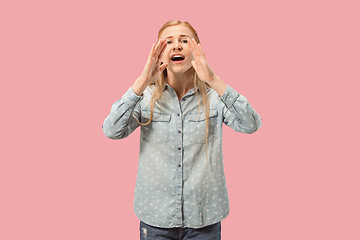 Image showing Isolated on pink young casual woman shouting at studio