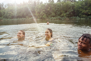 Image showing Enjoying river party with friends. Group of beautiful happy young people at the river together