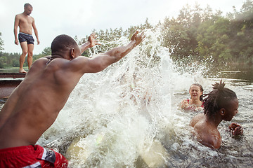 Image showing Enjoying river party with friends. Group of beautiful happy young people at the river together