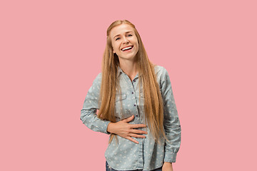 Image showing The happy business woman standing and smiling against pink background.