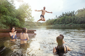 Image showing Enjoying river party with friends. Group of beautiful happy young people at the river together