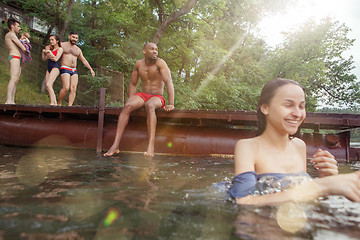 Image showing Enjoying river party with friends. Group of beautiful happy young people at the river together