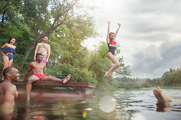 Image showing Enjoying river party with friends. Group of beautiful happy young people at the river together