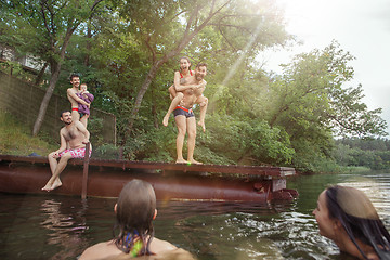 Image showing Enjoying river party with friends. Group of beautiful happy young people at the river together