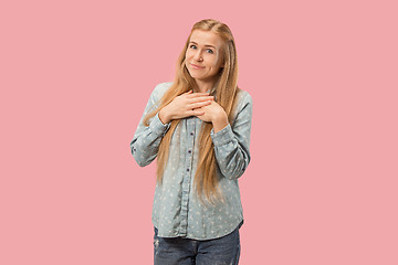 Image showing The happy business woman standing and smiling against pink background.