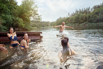 Image showing Enjoying river party with friends. Group of beautiful happy young people at the river together