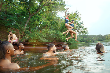 Image showing Enjoying river party with friends. Group of beautiful happy young people at the river together