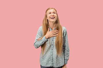 Image showing The happy business woman standing and smiling against pink background.