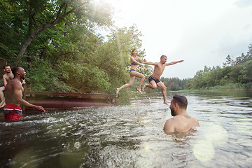 Image showing Enjoying river party with friends. Group of beautiful happy young people at the river together