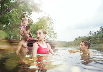 Image showing Enjoying river party with friends. Group of beautiful happy young people at the river together