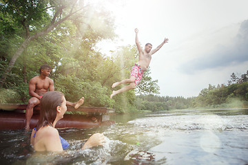 Image showing Enjoying river party with friends. Group of beautiful happy young people at the river together