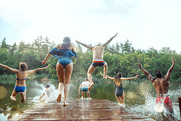 Image showing Enjoying river party with friends. Group of beautiful happy young people at the river together