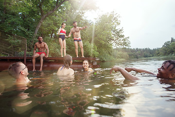 Image showing Enjoying river party with friends. Group of beautiful happy young people at the river together