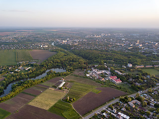 Image showing Aerial panoramic view from the drone to the national dendrological park Sofiyivka and the city of Uman, Ukraine in the summer at sunset