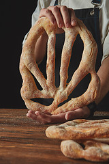 Image showing Hands men holding fougas bread