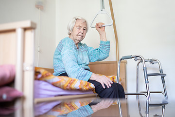 Image showing Elderly 96 years old woman sitting on medical bed in hospic.