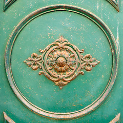 Image showing rusty ornamental decoration at a green door in Italy