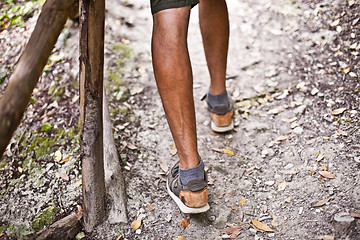 Image showing Man's legs on park or forest footpath with handrail closeup. 