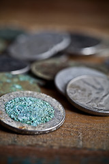 Image showing Pile of different ancient copper coins ccloseup on rustic wooden