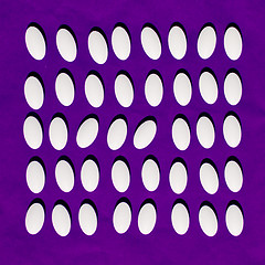 Image showing White pills on purple background. 