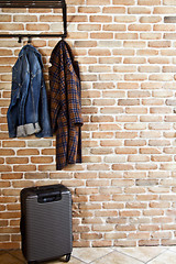 Image showing Modern hallway loft interior with denim coat and jacket on hange