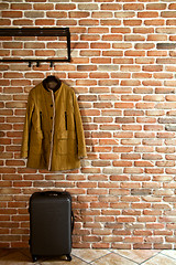 Image showing Modern hallway loft interior with mustard yellow jacket on hange