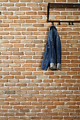 Image showing Modern hallway loft interior with denim coat on hanger against b