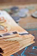 Image showing Pile of fifty euro banknotes and coins.