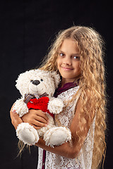 Image showing Portrait of a teenage girl with an old toy bear